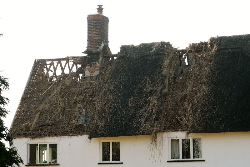 Farmhouse with fire-damaged roof